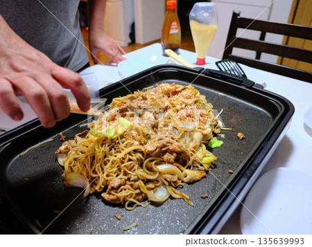 Cooking Yakisoba at a food stall Cooking Yakisoba at a food stall 135639993