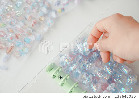 Sticking the popular Bonbon Drop stickers into a sticker book 135640039