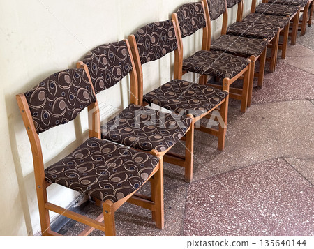 Row of patterned fabric chairs in a waiting area. Row of patterned fabric chairs in a waiting area. 135640144
