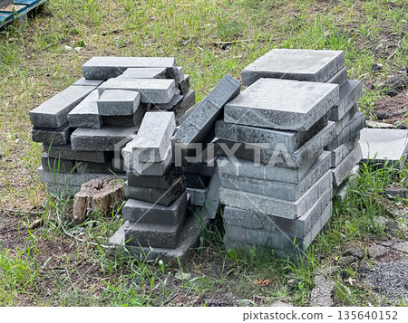 Stack of paving stones in a yard. 135640152