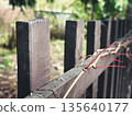 Weathered wooden fence in a rustic outdoor setting. 135640177
