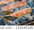 Grilled kebabs on skewers over a charcoal barbecue. 135640186