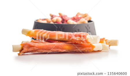 Dog food. Snack sticks for dogs isolated on white background. 135640600