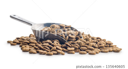 Dry pet food. Dry kibble food in scoop isolated on white background. 135640605
