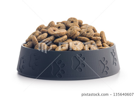 Dry pet food. Dry kibble food in bowl isolated on white background. Dry pet food. Dry kibble food in bowl isolated on white background. 135640607