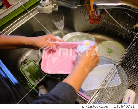 Hands of a woman washing dishes 135640751