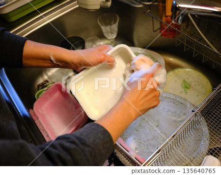 Hands of a woman washing dishes 135640765