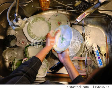 Hands of a woman washing dishes 135640783