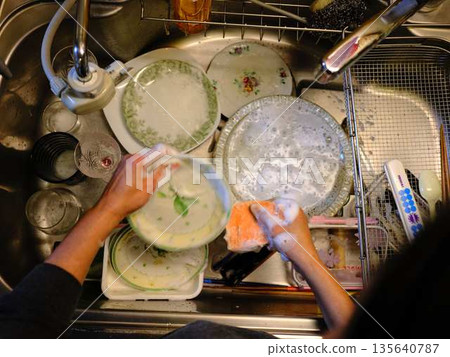Hands of a woman washing dishes 135640787