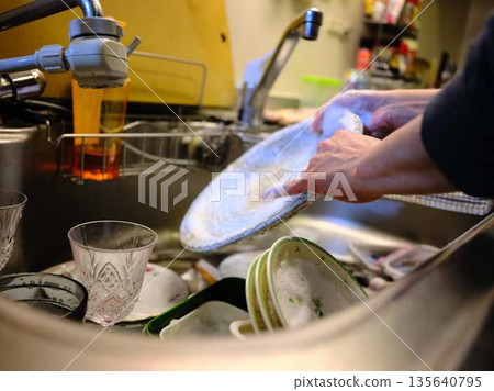 Hands of a woman washing dishes 135640795