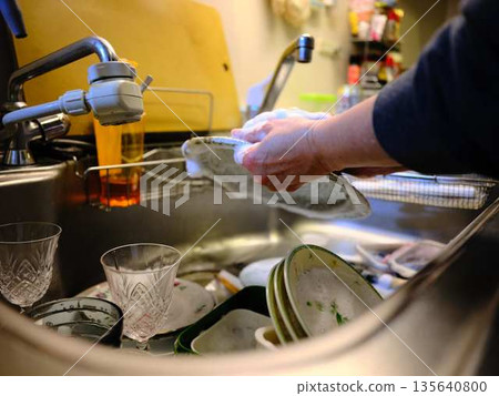 Hands of a woman washing dishes 135640800