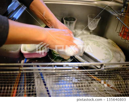 Hands of a woman washing dishes 135640803