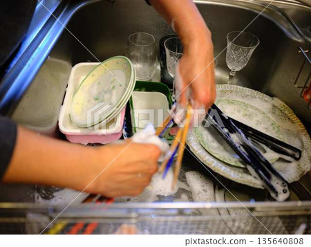 Hands of a woman washing dishes 135640808