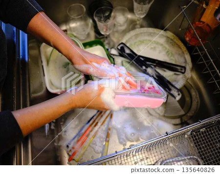 Hands of a woman washing dishes 135640826