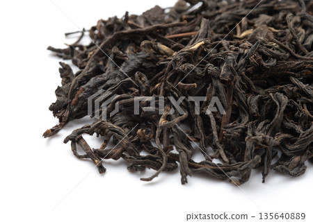 Pile of black tea on white background. Pile of black tea on white background. 135640889