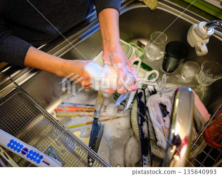 Hands of a woman washing dishes 135640993
