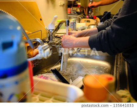 Hands of a woman washing dishes 135641033
