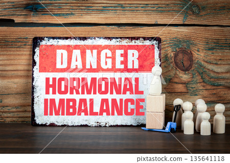DANGER HORMONAL IMBALANCE Warning Sign With Wooden Figures On Desk 135641118
