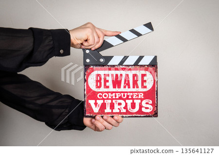 BEWARE COMPUTER VIRUS Cybersecurity Warning Sign Held With Film Clapper BEWARE COMPUTER VIRUS Cybersecurity Warning Sign Held With Film Clapper 135641127