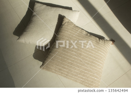 beige cushions lying on the floor beige cushions lying on the floor 135642494