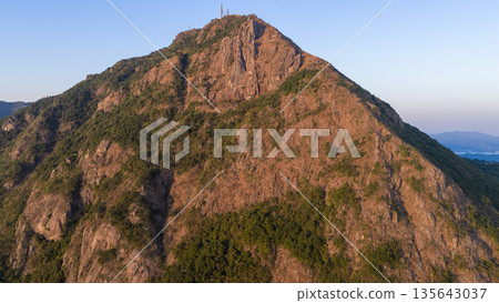 Jan 11 2026 Kowloon Peak overlooking Hong Kong skyline at sunse 135643037