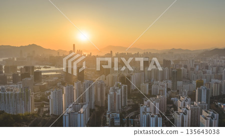 Jan 11 2026 Kowloon skyline glowing under warm golden sunset light 135643038