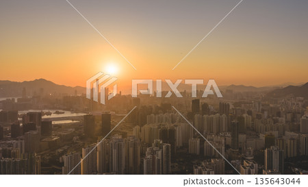 Jan 11 2026 Kowloon skyline glowing under warm golden sunset light 135643044