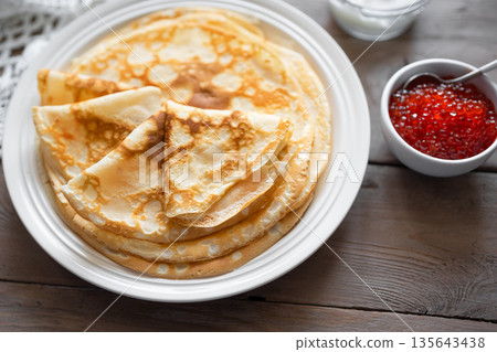 Thin crepes with red caviar 135643438