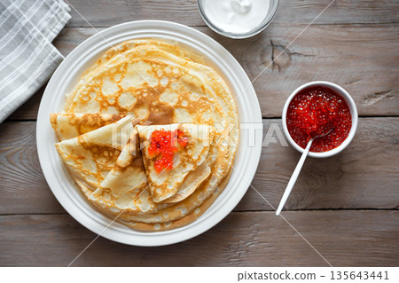 Homemade thin crepes with red caviar Homemade thin crepes with red caviar 135643441
