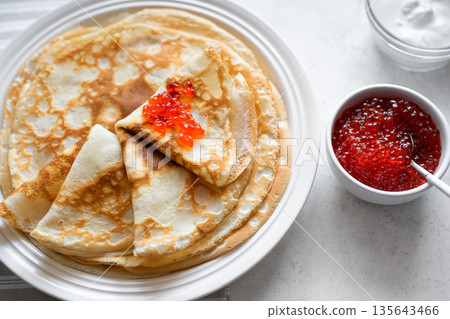 Homemade thin crepes with red caviar 135643466