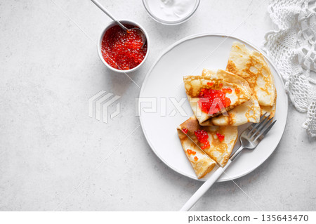 Thin crepes with red caviar 135643470
