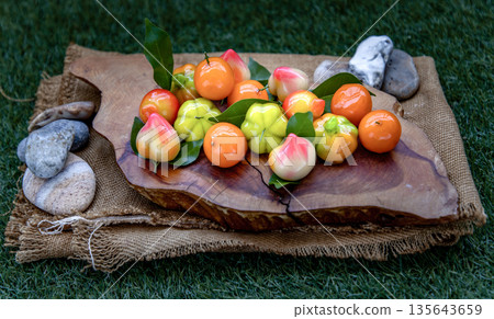 Kanom Look Choup : An old traditional thai dessert made from green been, coconut milk, sugar and jelly, Deletable imitation fruits made from green been, coconut milk, sugar and jelly in fruit shape on Kanom Look Choup : An old traditional thai dessert made from green been, coconut milk, sugar and jelly, Deletable imitation fruits made from green been, coconut milk, sugar and jelly in fruit shape on 135643659