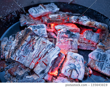 barbecue BBQ grill with flaming fire and ember charcoal on black background barbecue BBQ grill with flaming fire and ember charcoal on black background 135643819