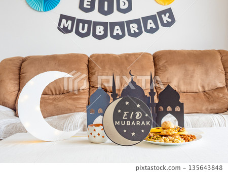 Eid Mubarak table with Ramadan sweets, dates, nuts and festive decor Eid Mubarak table with Ramadan sweets, dates, nuts and festive decor 135643848