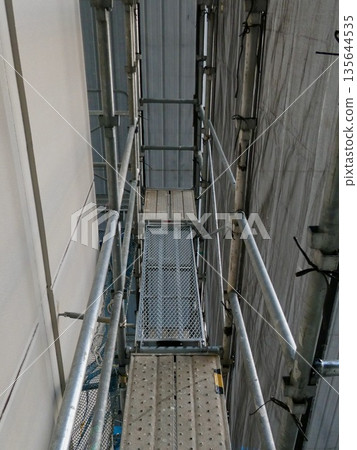 Scaffolding and walkways at a construction site Scaffolding and walkways at a construction site 135644535