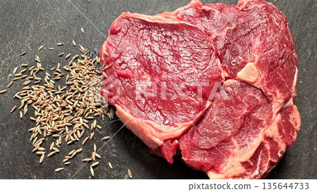 Chef Preparing Flavorful Ribeye With Cumin Seeds On Slate Background, Vivid Image Of Spiceenhanced Ribeye Steak Showcasing Marbling And Rustic Aesthetic For Culinary Visuals 135644733