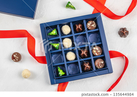 Luxury assorted chocolate gift box with red ribbon and copy space, flat lay 135644984