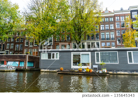 Amsterdam Canal with Houseboat and traditional house Building Amsterdam Canal with Houseboat and traditional house Building 135645343