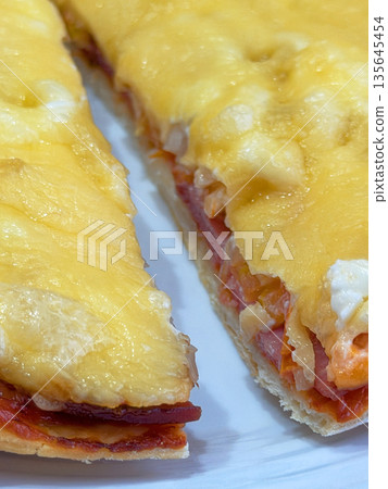 Cheesy pizza slice pull from board Cheesy pizza slice pull from board 135645454