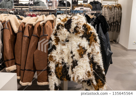 Stylish winter coats displayed in retail fashion store Stylish winter coats displayed in retail fashion store 135645564