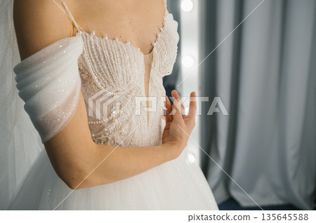 Elegant bride in beaded white wedding dress with sheer details Elegant bride in beaded white wedding dress with sheer details 135645588