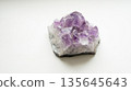 Amethyst crystal cluster on white background with purple and clear gemstones 135645643