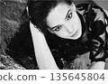 Attractive woman in stylish top posing on silver black and white 135645804