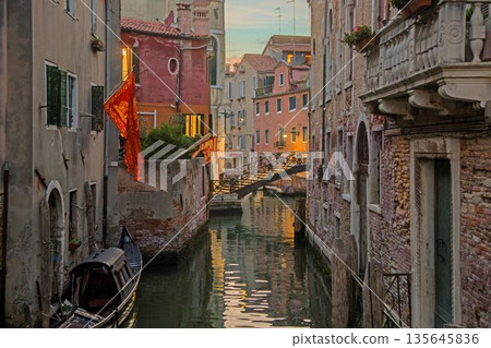 Small Venice bridge over quiet canal 135645836