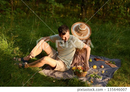 Serene couple sharing casual conversation outdoors during daylight Serene couple sharing casual conversation outdoors during daylight 135646007