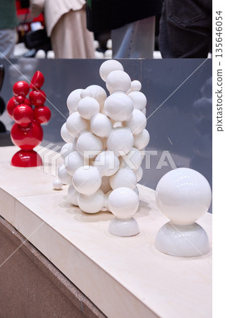 street exhibition with red and white sculptures visitors passing 135646054