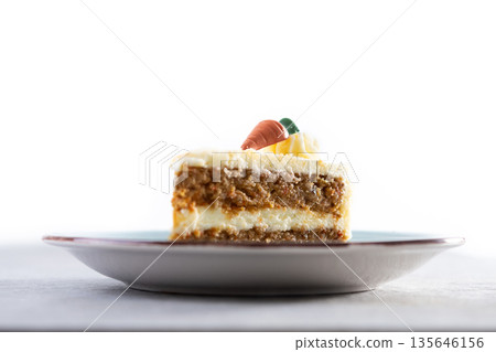 Carrot cake slice with cream cheese frosting 135646156