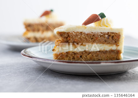 Carrot cake slice with cream cheese frosting 135646164
