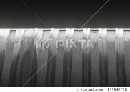A grayscale image of translucent white curtains 135646416