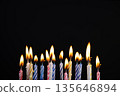 Many colorful birthday candles over black background with copy space. Birthday candles perfect for birthday celebrations, greeting cards, banners, or party decorations design. 135646894